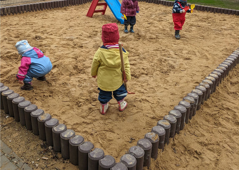 Kinder spielen in einem Sandkasten